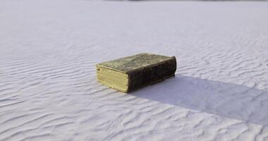 CGI Old book resting on textured sand in a serene outdoor location video