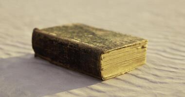 CGI Old book resting on textured surface during soft light of sunset video