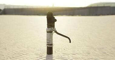 CGI Water pump standing alone in a desert landscape during golden hour light video