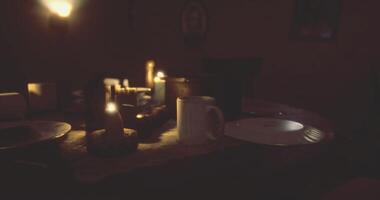 CGI Dinner table set with candles and dishes in a dimly lit room setting video