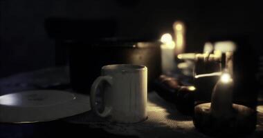CGI Candlelit table setting with a mug, plate, and wooden objects at dusk video