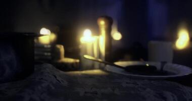CGI Soft candlelight illuminates a quiet dinner table at night video
