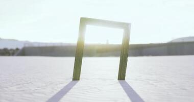 CGI Frame in the sand illuminated by sunlight on a clear day video