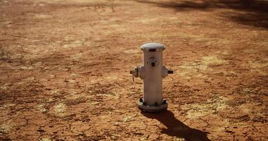 CGI Dry landscape featuring a white fire hydrant on cracked earth under sunlight video