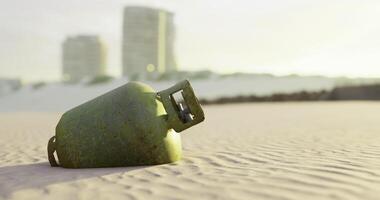 CGI Gas cylinder on beach at sunset with buildings behind it video