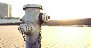 CGI Fire hydrant standing alone at sunset near a cityscape video