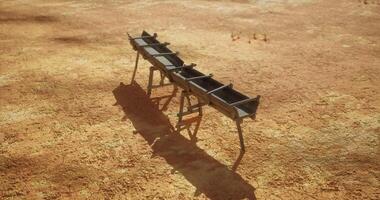 CGI Rustic trough stands alone in arid landscape under bright sun video