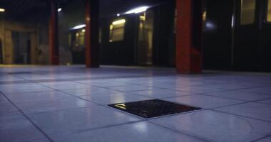 CGI Urban underground space with tiled floor and drain cover in dim lighting video