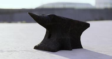 CGI Artistic metal anvil displayed on a smooth surface under bright sunlight video