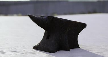 CGI Blacksmiths anvil resting on a white surface under bright sunlight video