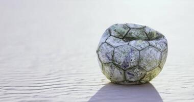 CGI Unique round stone resembling a soccer ball resting on sandy beach video
