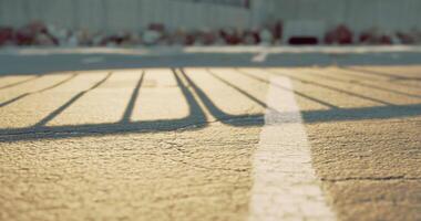 CGI Sunlight casting shadows on pavement in an empty parking lot during sunset video
