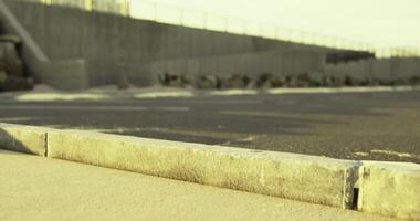 CGI View of a concrete pathway by a coastal area at sunset with rocks and barriers video