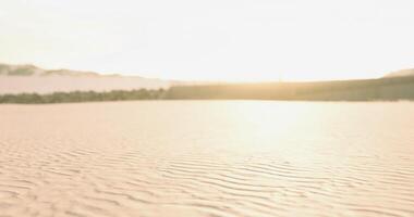 CGI Morning light illuminates sandy beach with gentle waves in the distance video