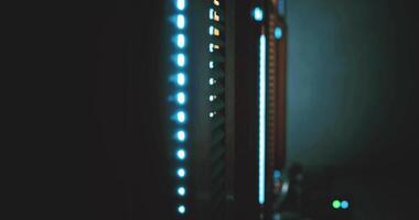 CGI Servers illuminated with blue lights in a dark data center during nighttime video
