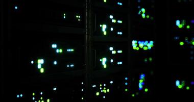 CGI Bright lights illuminate server racks in a dark data center at night video