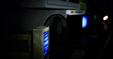 CGI Vintage computer setup illuminated in a dimly lit room with retro decor video
