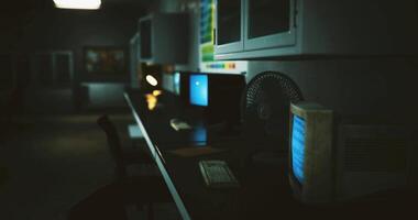 CGI Nostalgic computer setup in a dimly lit room with retro technology video