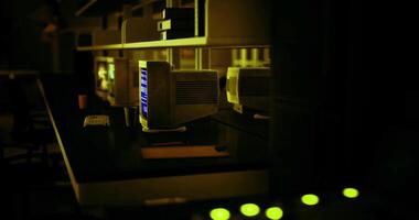 CGI Retro computer setup in a darkened room with glowing screens and keyboard video