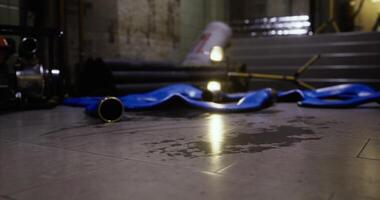 CGI Water pooling on floor with equipment scattered in dimly lit area video