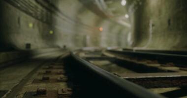 CGI Tracks stretch into the dim distance in an urban underground tunnel video