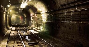 CGI Dark underground tunnel with illuminated tracks and pipes in the background video