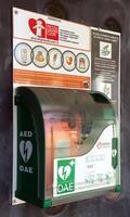 Bologna Italy April 9, 2022 Public access defibrillator unit mounted on a wall available for use in cardiac arrest emergencies. photo