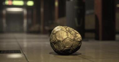 CGI Lost soccer ball rests on tiled floor in dimly lit urban space video