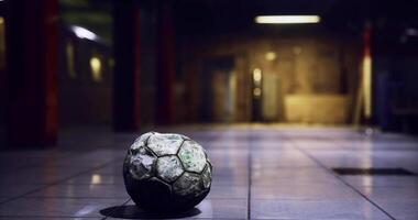 CGI Abandoned soccer ball rests on the floor of a dimly lit indoor space video
