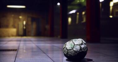 CGI Soccer ball rests on tiled floor in dimly lit underground space video