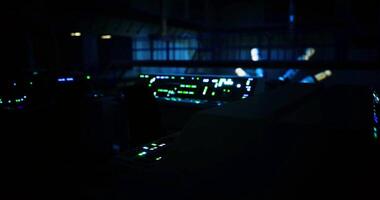 CGI Control room illuminated by glowing screens in a dark environment video