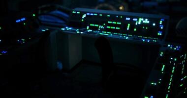 CGI Brightly glowing control panel in a dark room during late night operations video