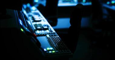 CGI Control panel glows softly in darkened room of modern broadcast studio video