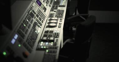 CGI Control room equipment with various buttons and screens in dim lighting video