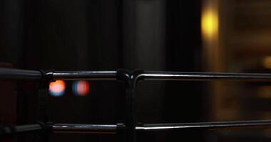 CGI Urban nightlife captured through a metal railing with blurred lights video