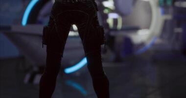 CGI Futuristic character in dark attire stands ready in a high tech environment video