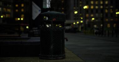 CGI Urban night scene with a trash can illuminated by streetlights in the city video