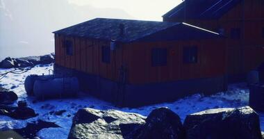 CGI Mountains backdrop with wooden cabins and rocky terrain during early morning video