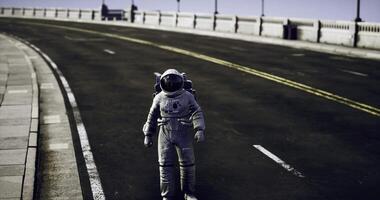CGI Astronaut walking along an empty roadway near a futuristic cityscape at dusk video