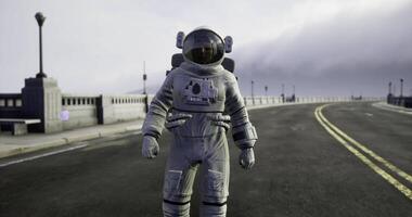 CGI Astronaut standing on deserted road under cloudy sky during afternoon video