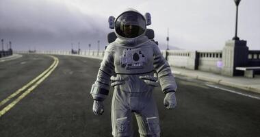 CGI Astronaut walks on an empty road under a cloudy sky at dusk video