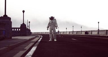 CGI Astronaut walking on empty road near bridge during cloudy day video
