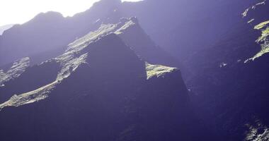CGI Majestic mountain peaks illuminated by sunlight in a serene landscape video