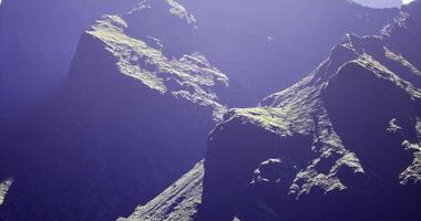 CGI Majestic mountain range under bright sunlight with rugged terrain in focus video