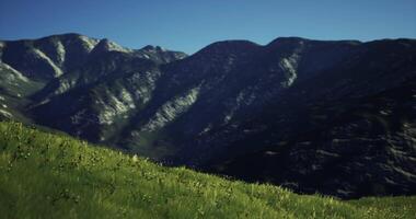CGI Mountains rise majestically under a clear blue sky during daylight hours video