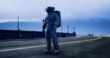CGI Astronaut walking on empty urban road under cloudy sky near a bridge video