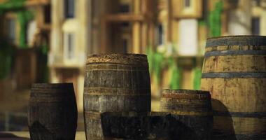 CGI Barrels of various sizes placed outdoors in a sunny environment near buildings video
