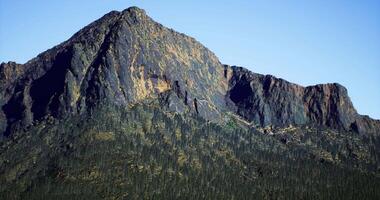 CGI Mountain peak stands tall against a clear blue sky, showcasing nature video