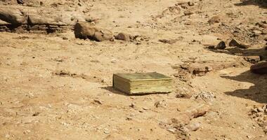 CGI Mysterious book resting on arid ground at remote desert location video