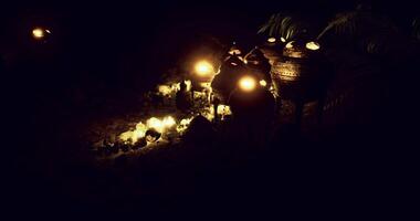 CGI Warm glow of candlelit pottery displayed in a serene outdoor setting at night video